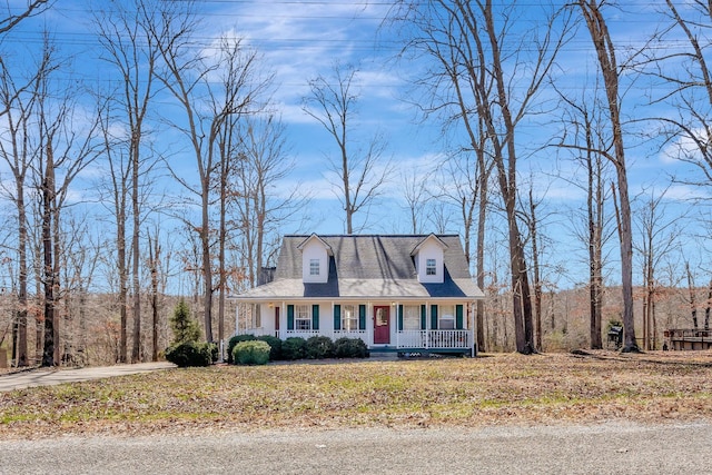 new england style home featuring covered porch