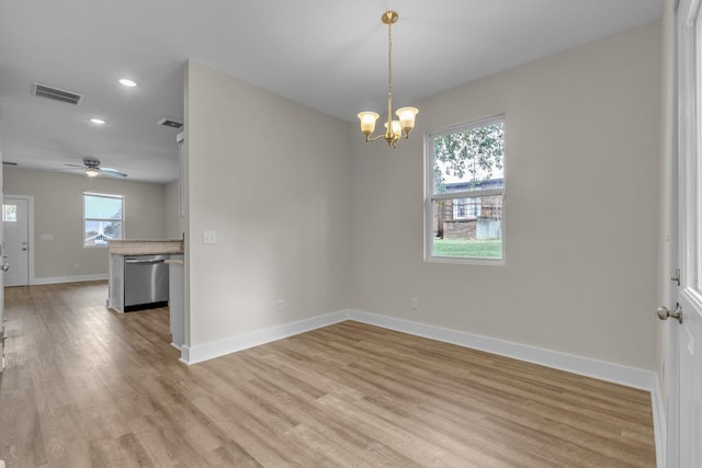 empty room with recessed lighting, visible vents, light wood-style flooring, baseboards, and ceiling fan with notable chandelier