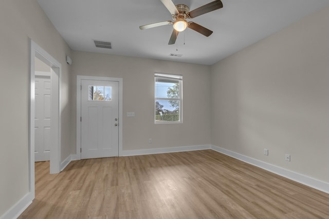 foyer featuring light wood-type flooring, visible vents, and baseboards