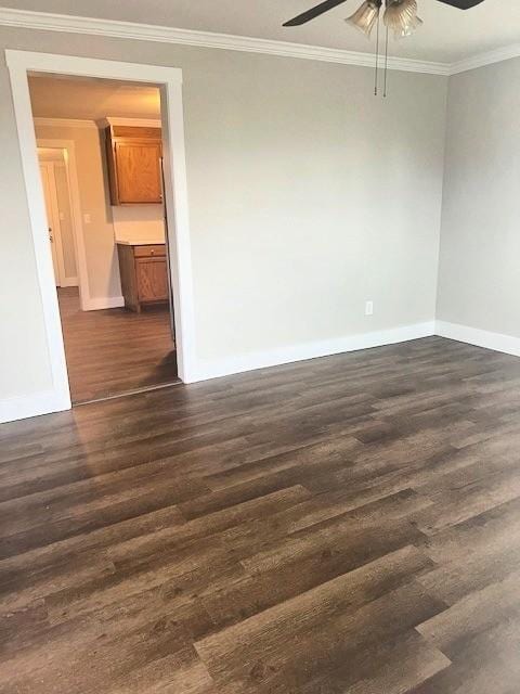 unfurnished room featuring baseboards, ceiling fan, ornamental molding, and dark wood-type flooring