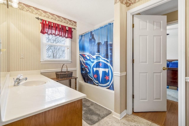 full bathroom featuring a textured ceiling, shower / bathtub combination with curtain, tile patterned flooring, vanity, and crown molding