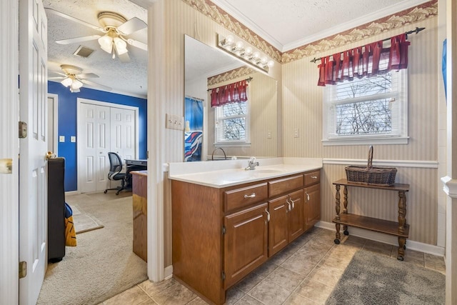 full bathroom with a wainscoted wall, crown molding, visible vents, a textured ceiling, and vanity