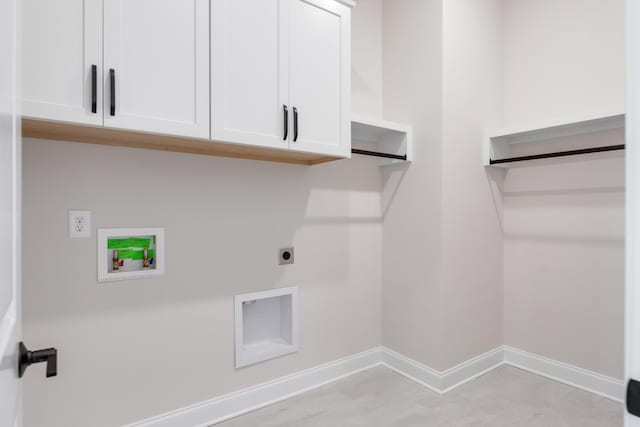 washroom featuring washer hookup, cabinet space, electric dryer hookup, and baseboards