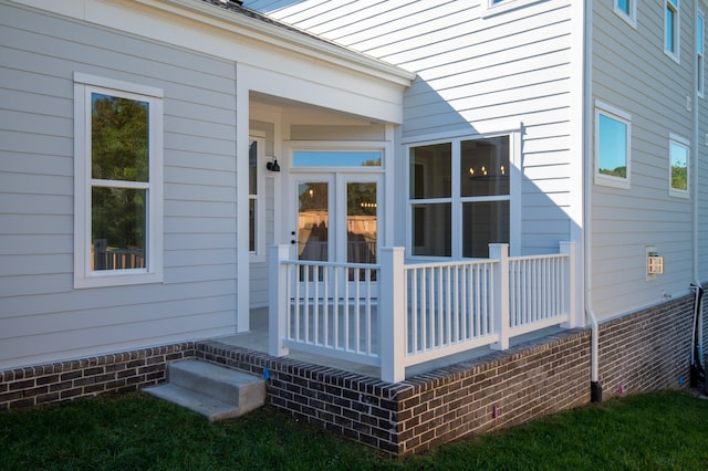 view of exterior entry featuring covered porch