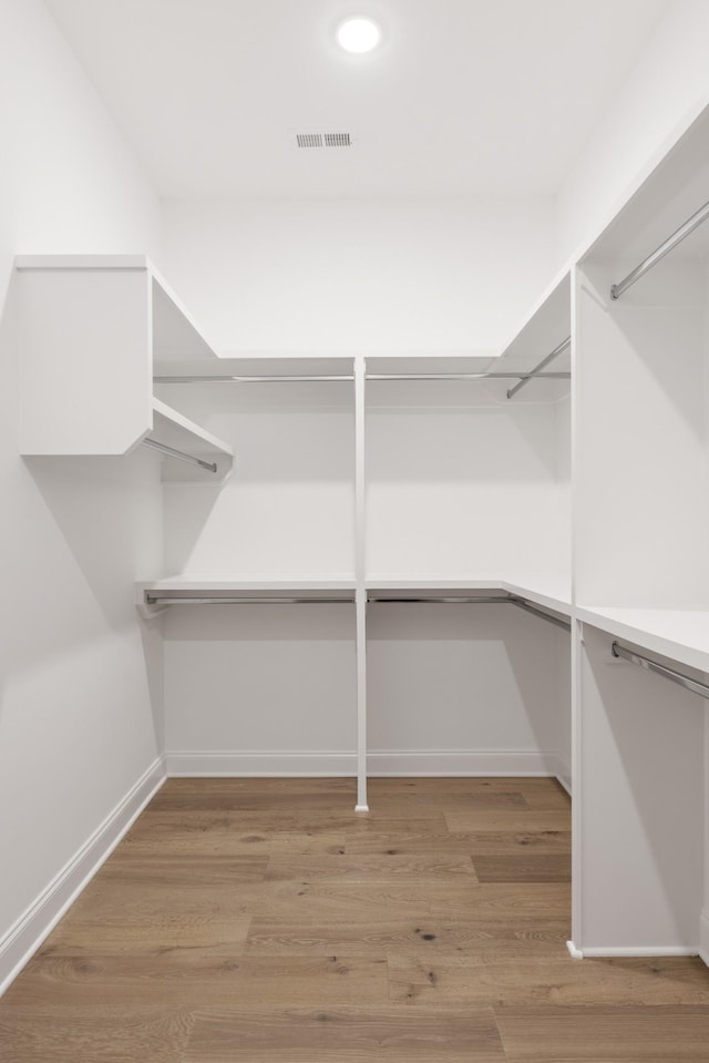 spacious closet featuring visible vents and light wood-style flooring