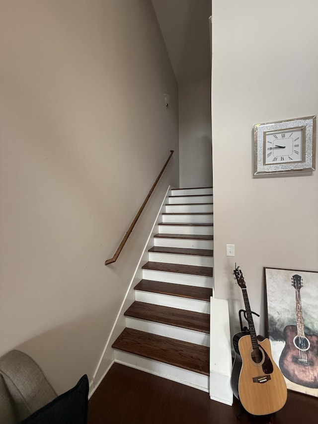 stairway featuring baseboards and wood finished floors