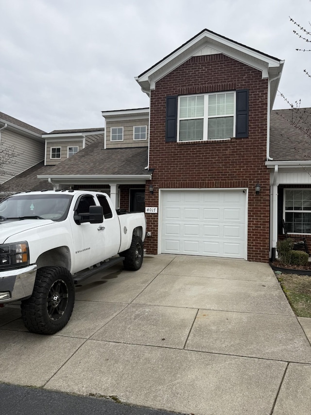 traditional-style house featuring a garage, brick siding, and driveway