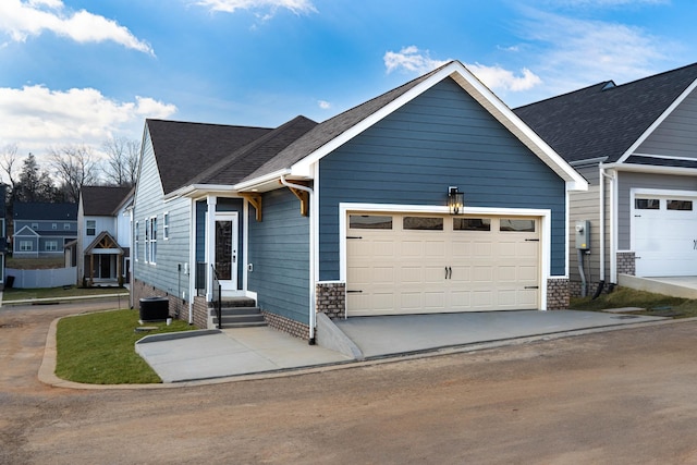 view of front of property with an attached garage, concrete driveway, and roof with shingles