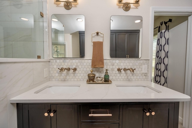 bathroom featuring tasteful backsplash, walk in shower, a sink, and double vanity