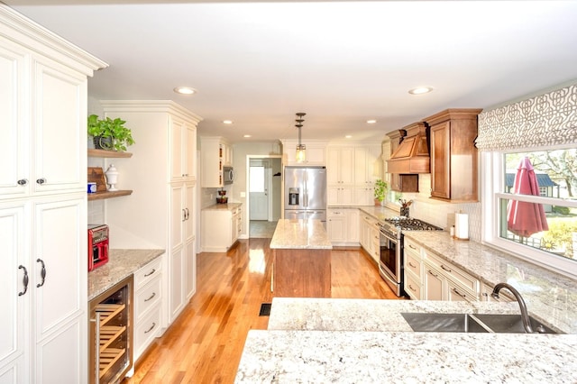 kitchen with wine cooler, light wood-style flooring, a sink, appliances with stainless steel finishes, and custom range hood