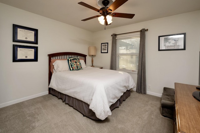 bedroom featuring light carpet, ceiling fan, and baseboards