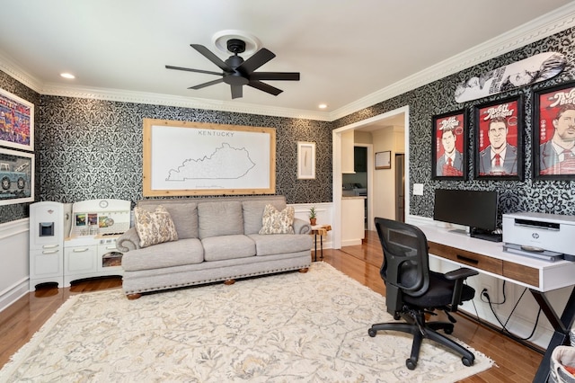 office area with ornamental molding, wood finished floors, a wainscoted wall, and wallpapered walls