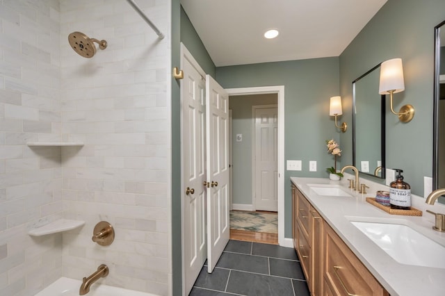 bathroom with tile patterned flooring, a sink, shower / tub combination, and double vanity