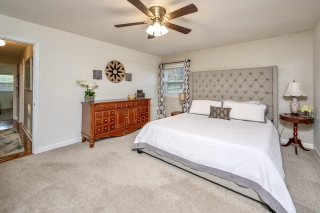 carpeted bedroom featuring a ceiling fan and baseboards