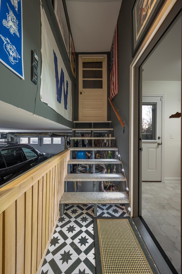 stairway with tile patterned floors