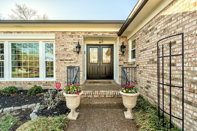 view of exterior entry featuring brick siding