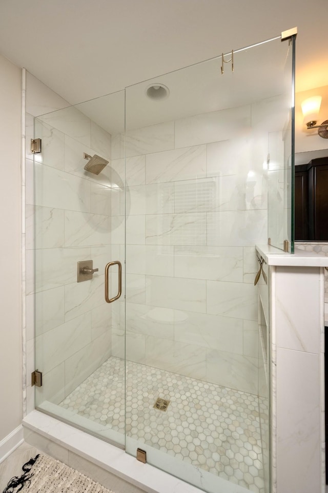 full bath with a shower stall and vanity