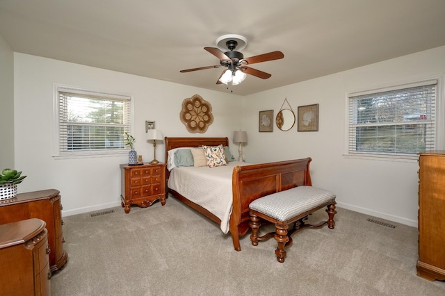 bedroom featuring carpet floors, a ceiling fan, visible vents, and baseboards