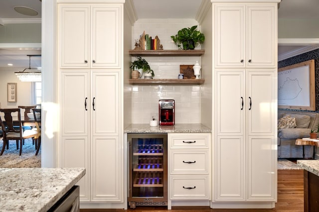 bar with beverage cooler, crown molding, backsplash, and wood finished floors