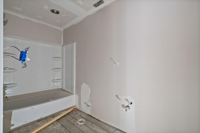 bathroom with shower / bathing tub combination and wood finished floors