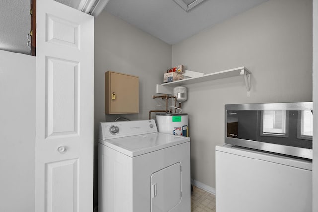 washroom with washer / dryer, laundry area, baseboards, light floors, and water heater