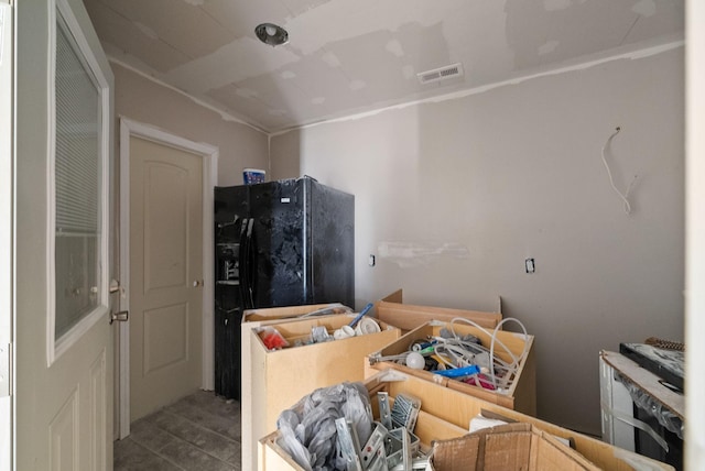 kitchen featuring freestanding refrigerator and visible vents