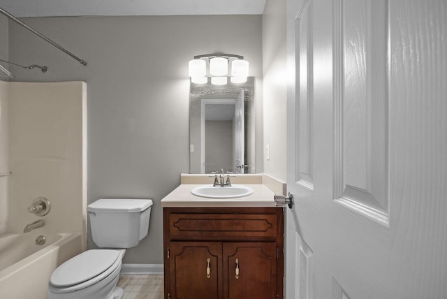 bathroom featuring toilet, shower / bathing tub combination, vanity, and baseboards