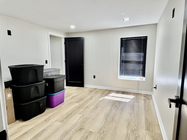 unfurnished room with baseboards, wood finished floors, and recessed lighting