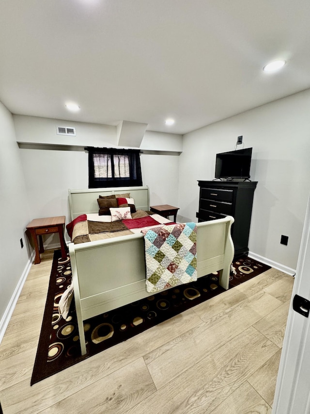 bedroom with recessed lighting, visible vents, baseboards, and wood finished floors