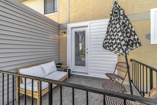 view of exterior entry with an outdoor living space and stucco siding