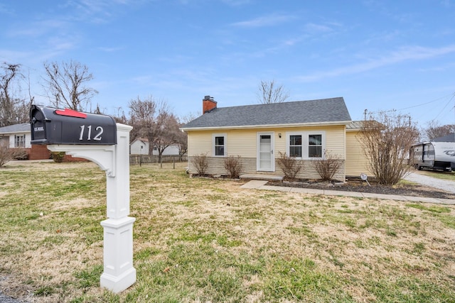 view of front of property featuring a chimney and a front lawn