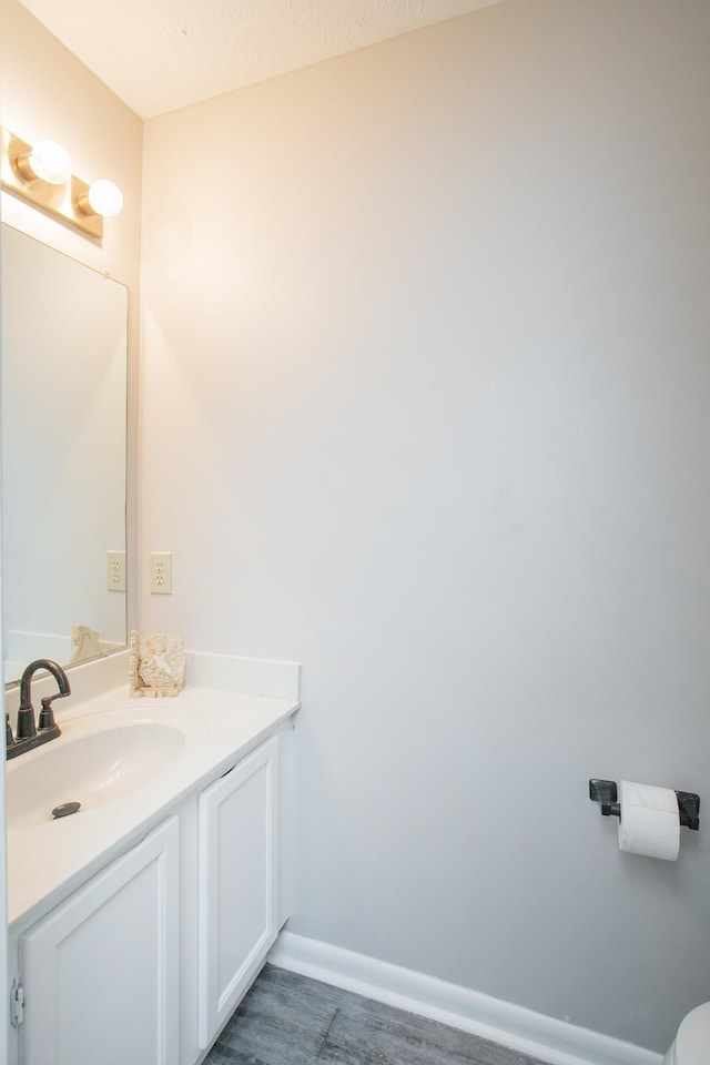 bathroom with vanity and baseboards