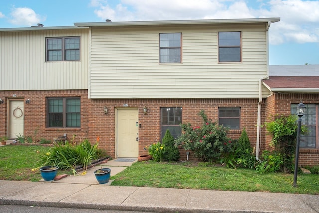 view of front of property with brick siding and a front yard