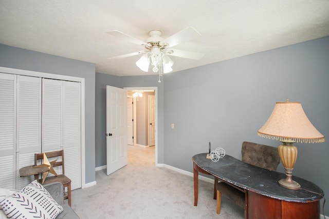 office area featuring light colored carpet, ceiling fan, and baseboards