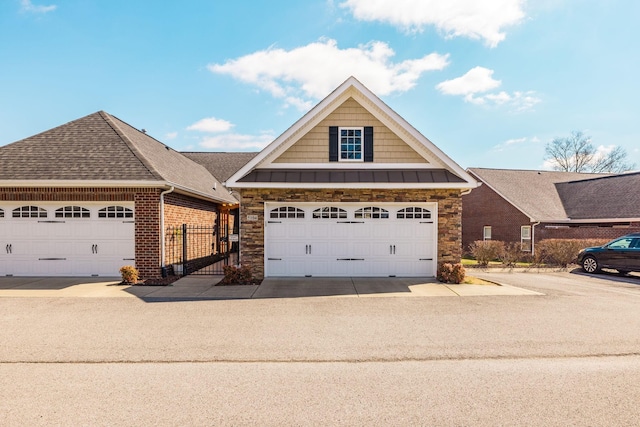 view of front of house featuring stone siding and roof with shingles