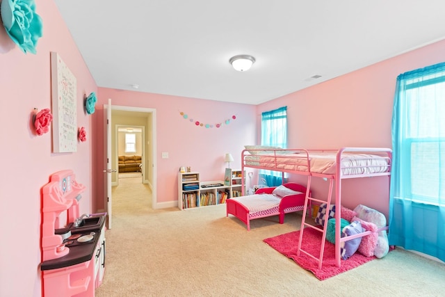 carpeted bedroom with multiple windows, visible vents, and baseboards