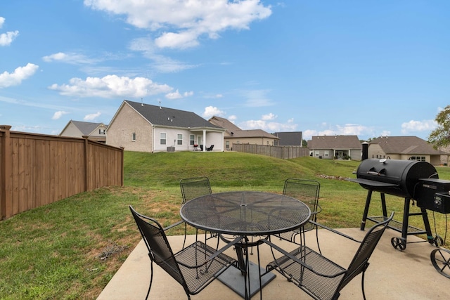 view of patio with a fenced backyard, a residential view, a grill, and outdoor dining area