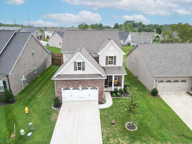 view of front of property with driveway, brick siding, a front lawn, and a residential view