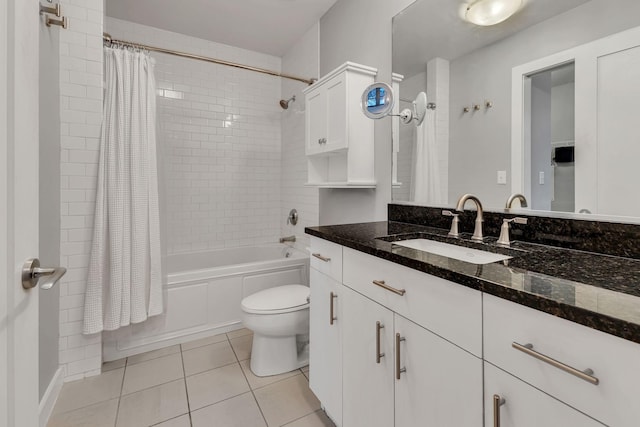 bathroom with toilet, vanity, shower / bath combo with shower curtain, and tile patterned floors