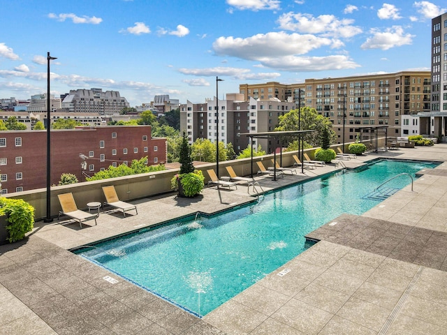 pool with a view of city and a patio