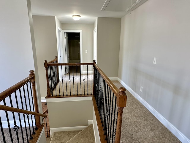 stairway with attic access, carpet flooring, and baseboards