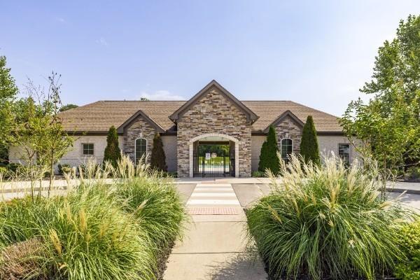 french provincial home with a gate