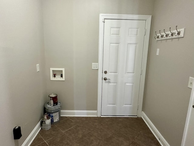 washroom featuring hookup for a washing machine, laundry area, dark tile patterned floors, and baseboards