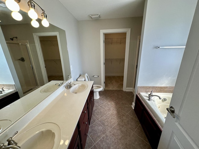 bathroom featuring visible vents, a sink, a shower stall, and double vanity