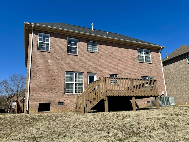 back of property with central air condition unit, brick siding, stairs, crawl space, and a wooden deck