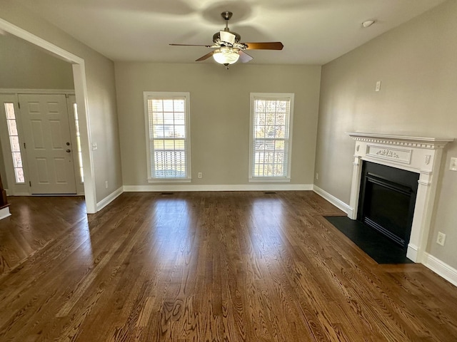 unfurnished living room with a fireplace with flush hearth, baseboards, and dark wood-type flooring