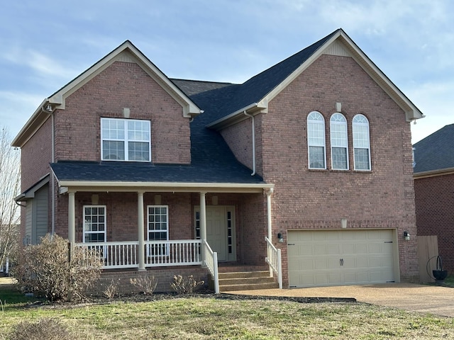 traditional home with a garage, covered porch, brick siding, and driveway