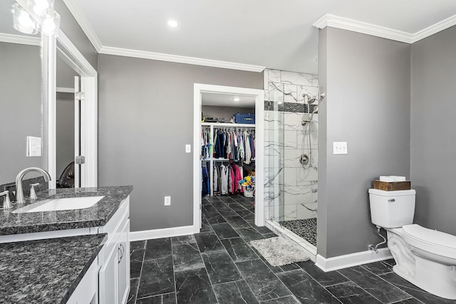 bathroom with a stall shower, baseboards, toilet, crown molding, and vanity