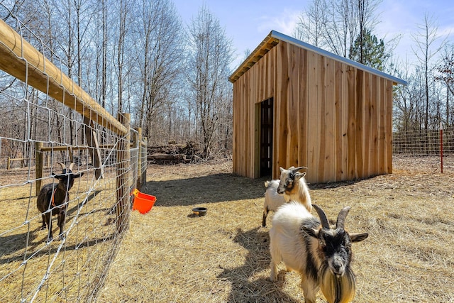 view of shed featuring fence