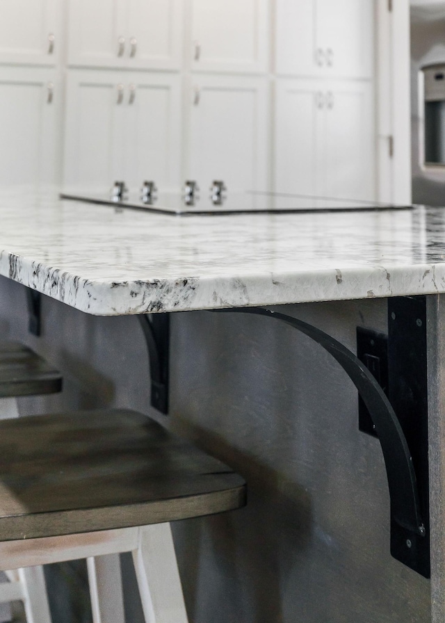 details with light stone counters and white cabinetry